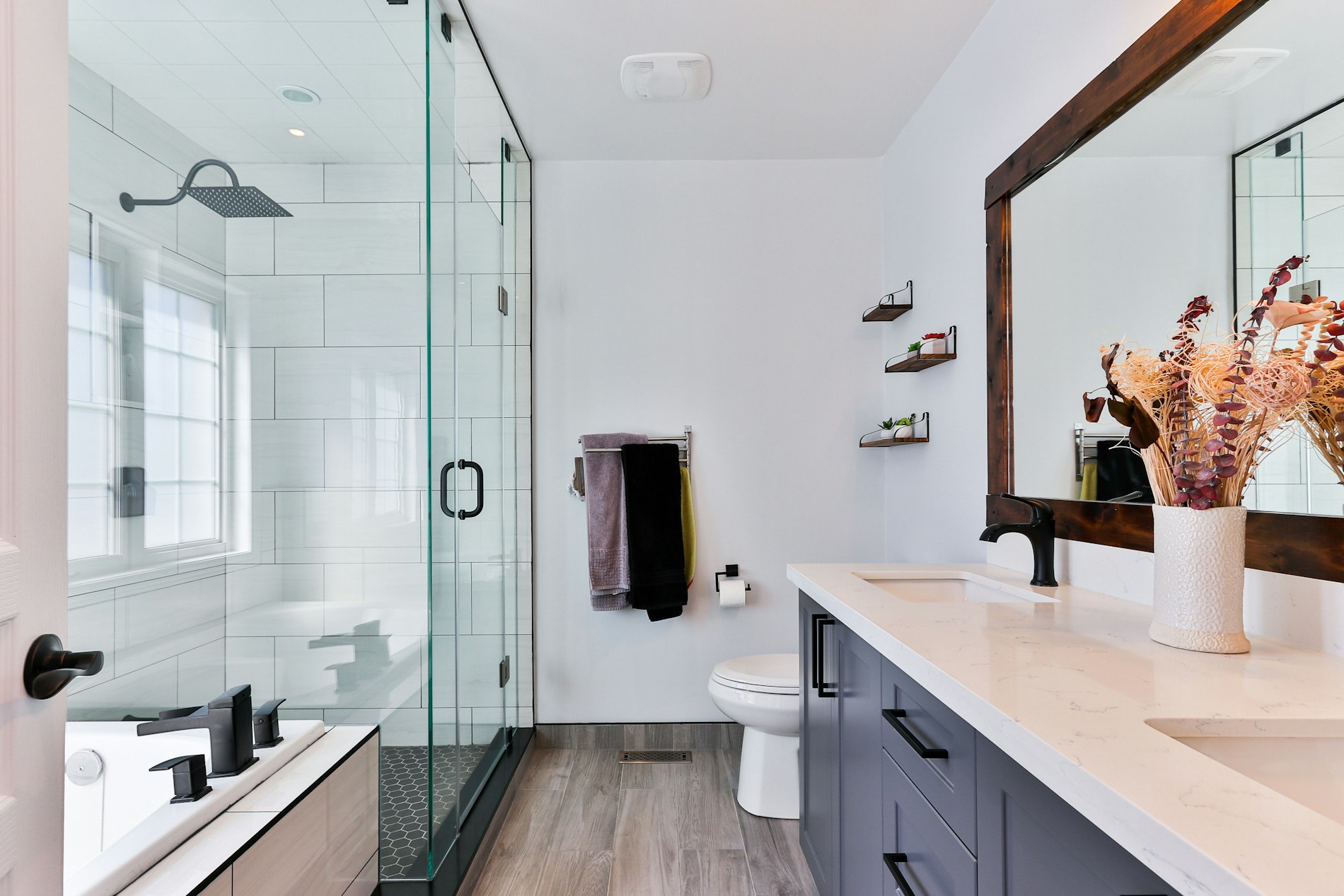 Modern spa-style bathroom with a walk-in glass shower and marble vanity